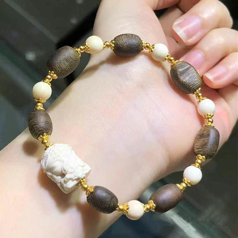 Agarwood oval bead bracelet with carved Buddha head and gold bead spacers, vintage cultural and artistic bracelet | Diyjade
