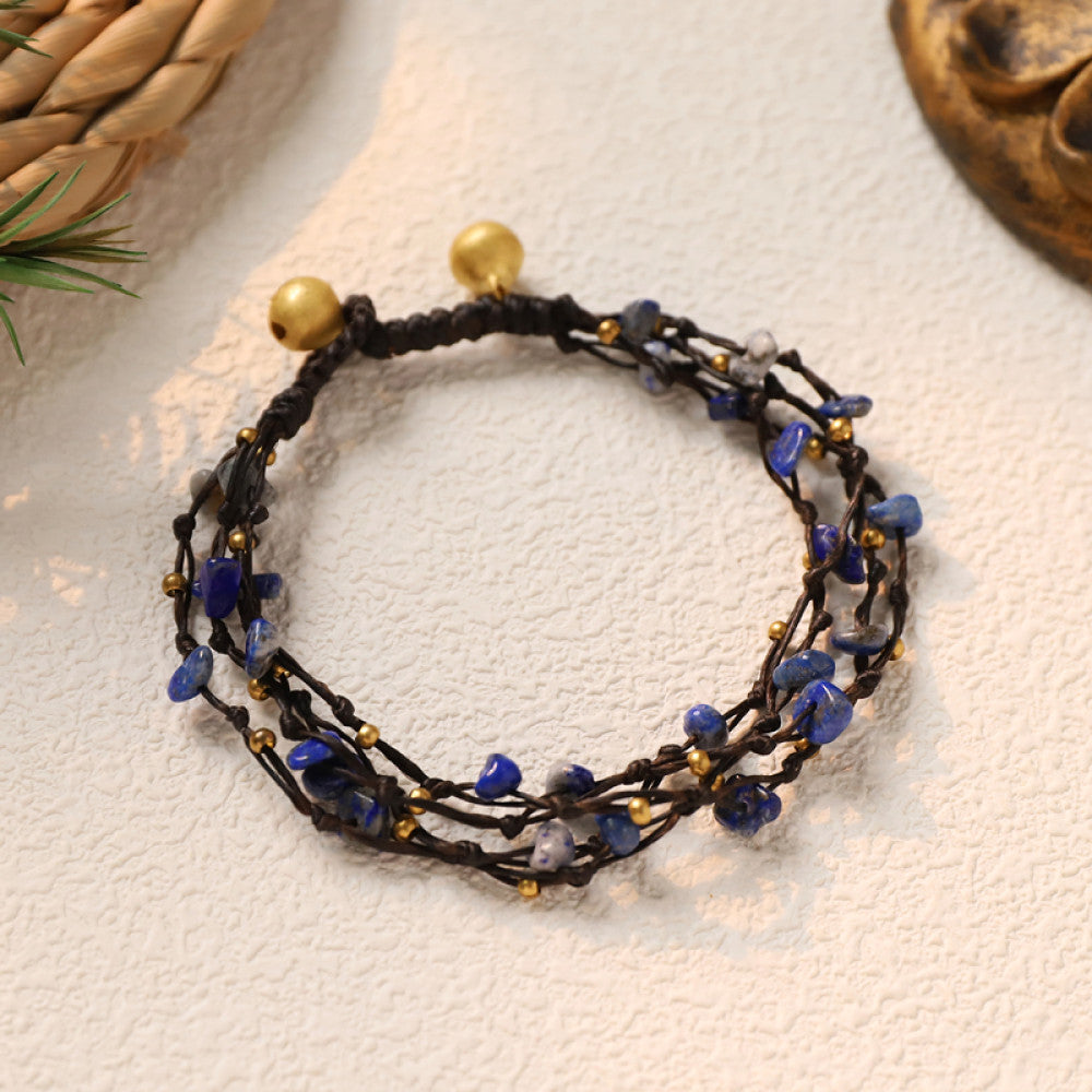 This multi-layered bohemian bracelet features black braided cords adorned with natural amethyst chips and gold beads, finished with golden accent beads. A unique, earthy accessory for everyday style 07