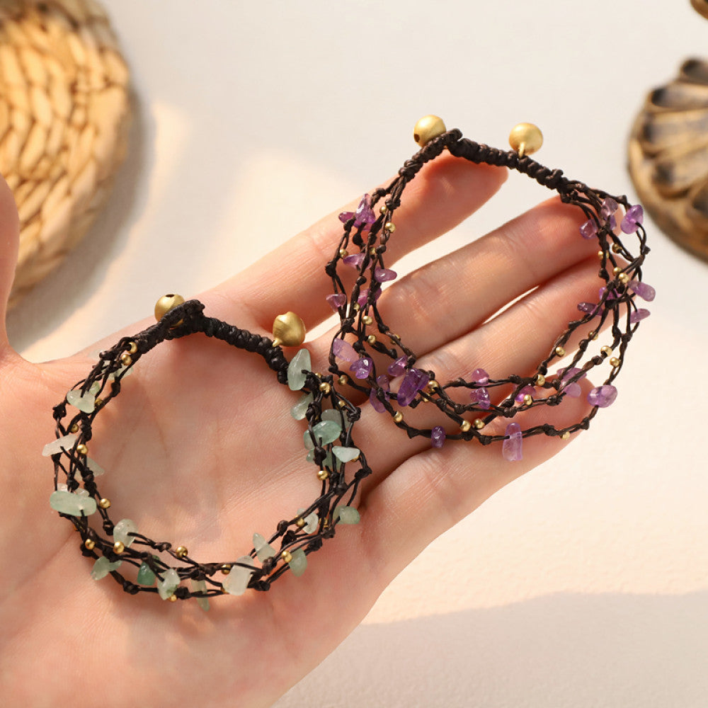 This multi-layered bohemian bracelet features black braided cords adorned with natural amethyst chips and gold beads, finished with golden accent beads. A unique, earthy accessory for everyday style 10