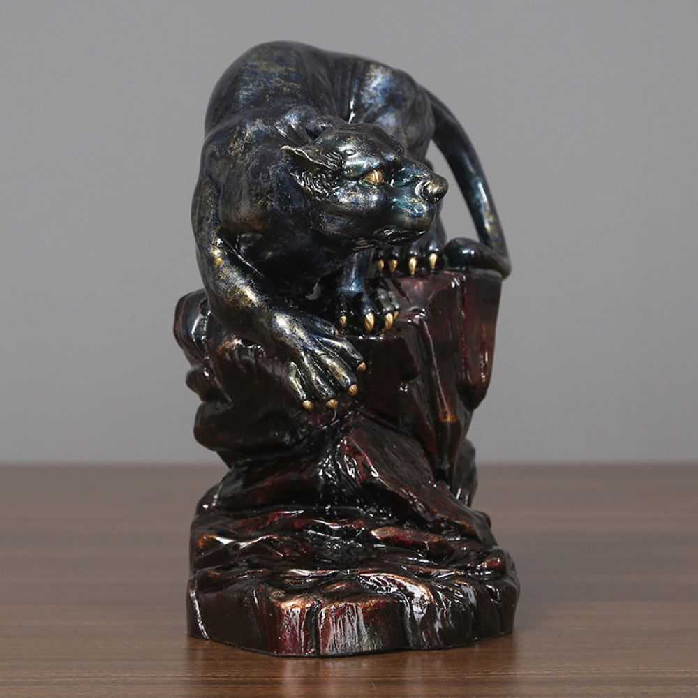 Art Deco style crouching panther statue with blue and metallic finishes, perched on a detailed rocky base (a symbol of strength & courage), displayed on a wooden surface against a gray background 03