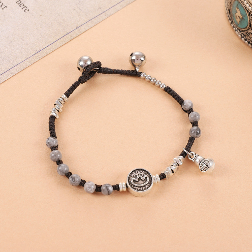 Black beads with engraved round tag, sleek and mysterious.