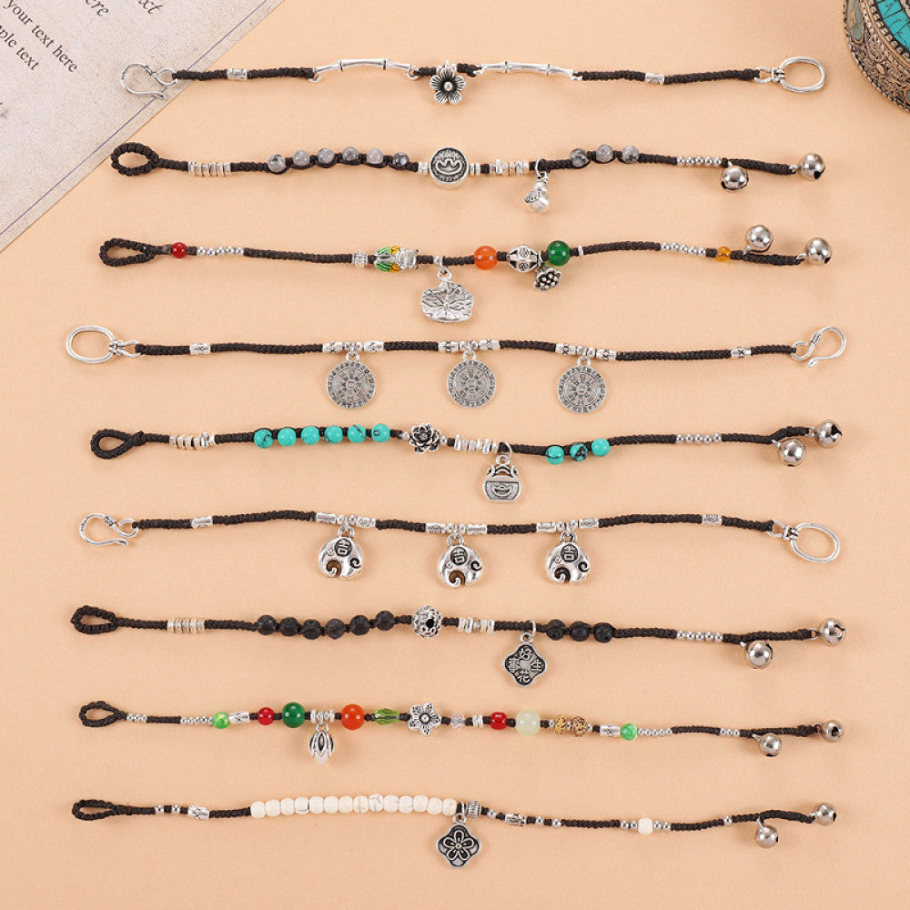 Multiple matching black cord bracelets, perfect for layering.