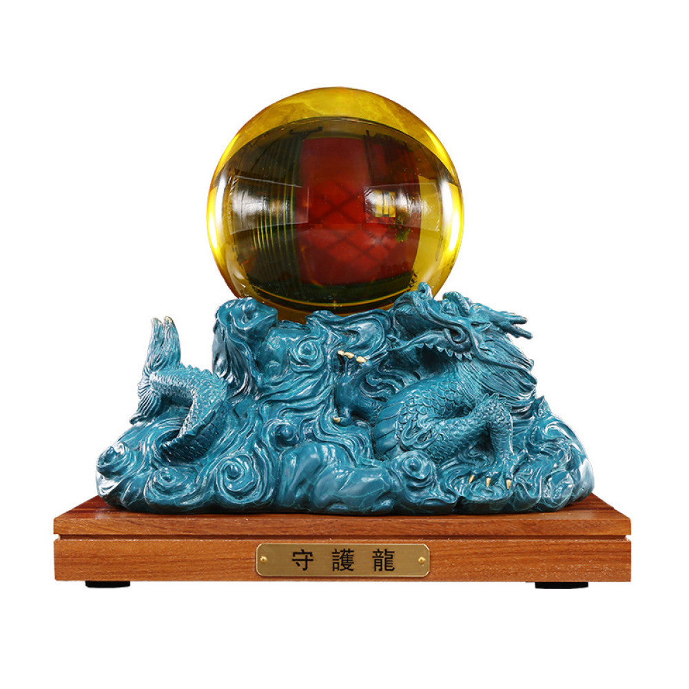 Blue dragon crystal ball statue with intricate carvings, a Feng Shui symbol of good fortune, displayed as elegant home decor on a wooden base in an office setting against a gray background 02
