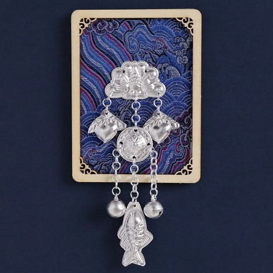 Blue floral refrigerator magnet with silver hanging charms.