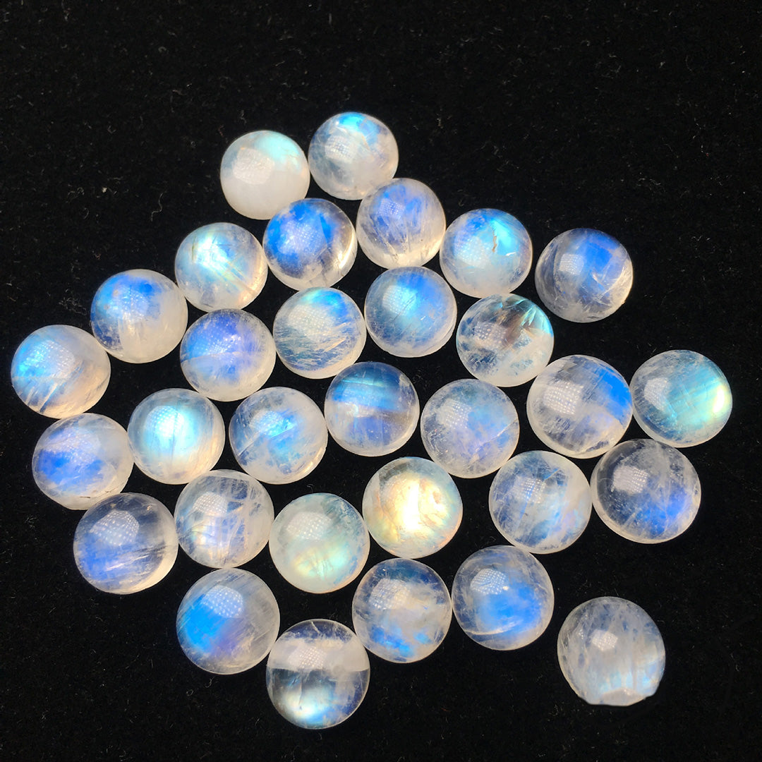 Round moonstone with obvious blue moonlight effect, multiple pieces on display, showing the charm of gemstones