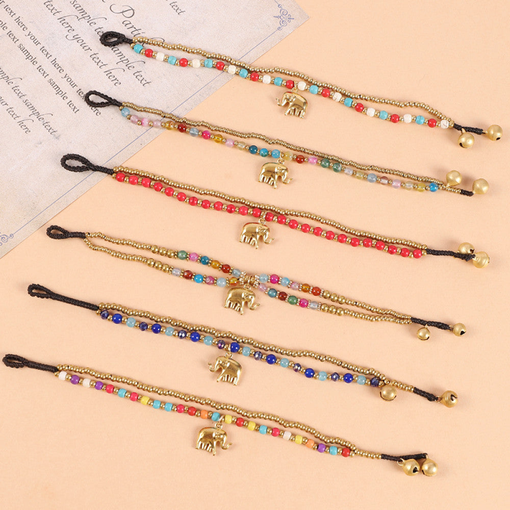 This double-layered bohemian bracelet features vibrant multicolored beads, golden bells, and a charming gold elephant charm. The adjustable knot closure ensures a perfect fit, adding a playful, ethnic-inspired touch to any outfit 10