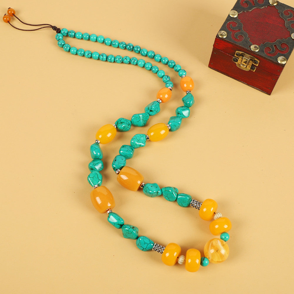 Vintage bohemian ethnic tribal necklace with multi-color beads (black, orange, red, turquoise, yellow) and intricate patterned accents, ideal for boho chic fashion, displayed against a neutral background with a vintage box accent 02