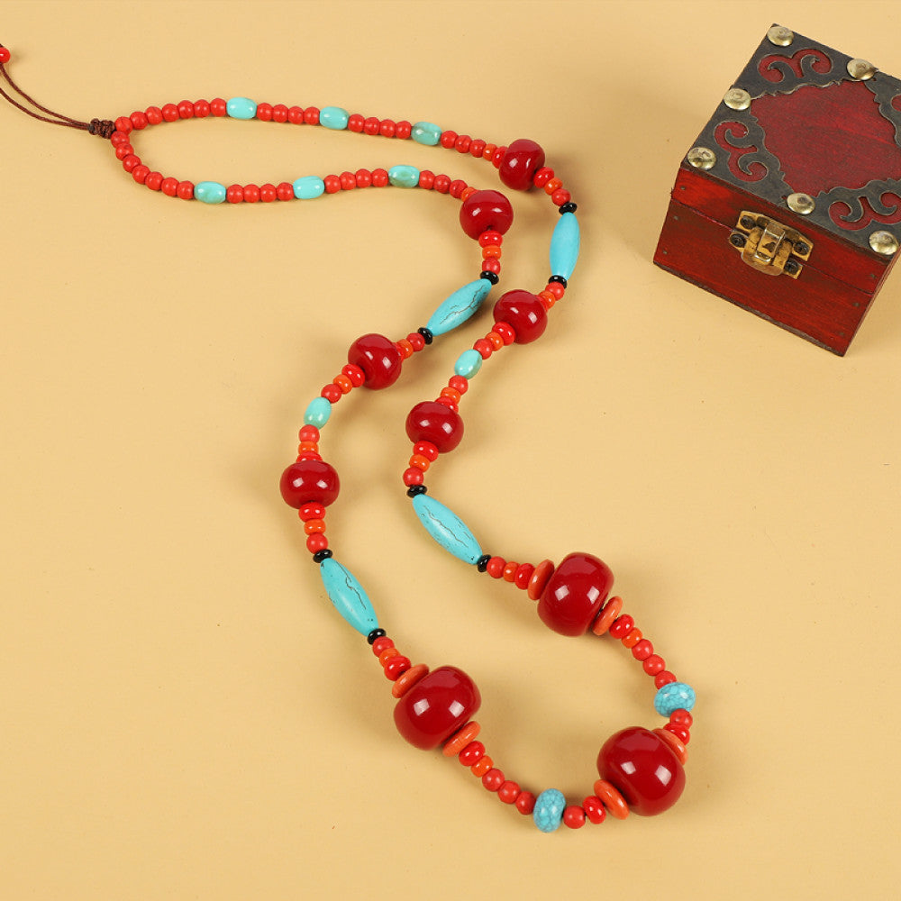 Vintage bohemian ethnic tribal necklace with multi-color beads (black, orange, red, turquoise, yellow) and intricate patterned accents, ideal for boho chic fashion, displayed against a neutral background with a vintage box accent 03