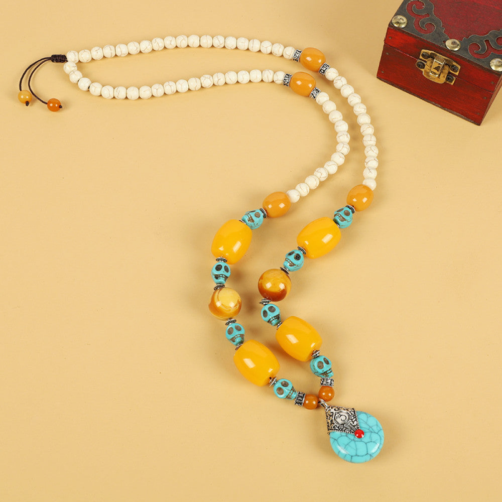 Vintage bohemian ethnic tribal necklace with multi-color beads (black, orange, red, turquoise, yellow) and intricate patterned accents, ideal for boho chic fashion, displayed against a neutral background with a vintage box accent
 07