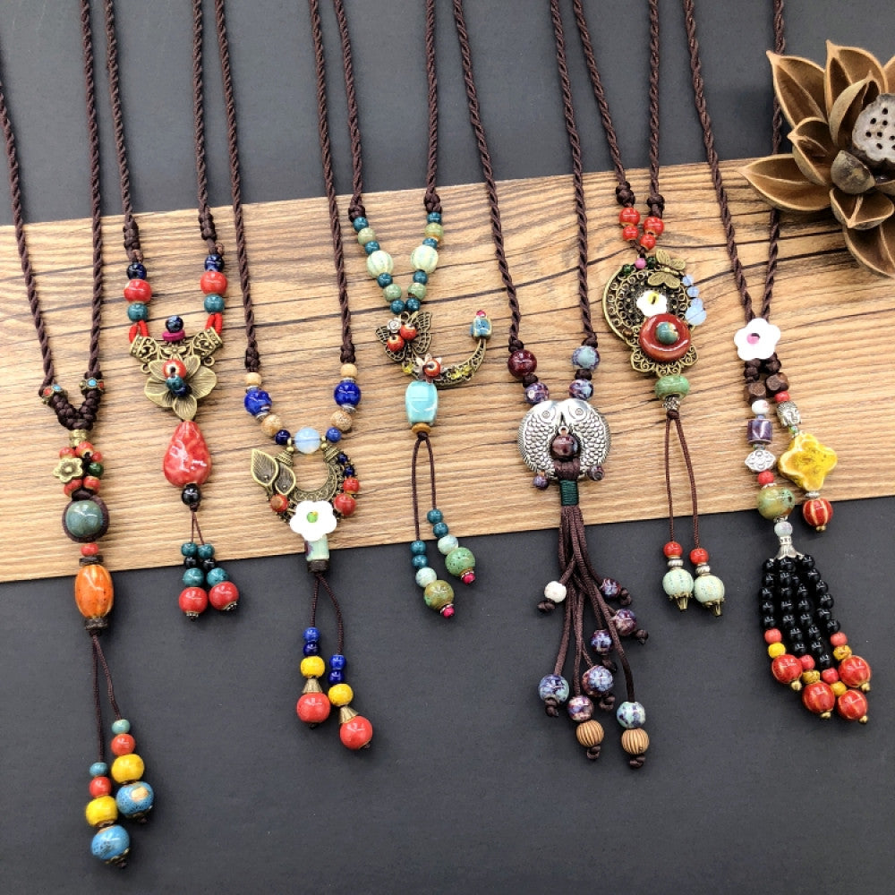 Assorted bohemian ethnic tribal vintage necklace set with colorful beaded and various pendant designs, displayed on a wooden board, ideal for boho fashion enthusiasts