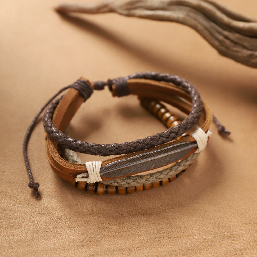 This bohemian stackable bracelet set features multiple layered strands in earthy tones, including turquoise, dark brown, green, and light brown beads, accented with decorative silver elements. The mix of natural materials and ethnic-inspired details creates a rich, textured look, perfect for layering to elevate casual outfits 00