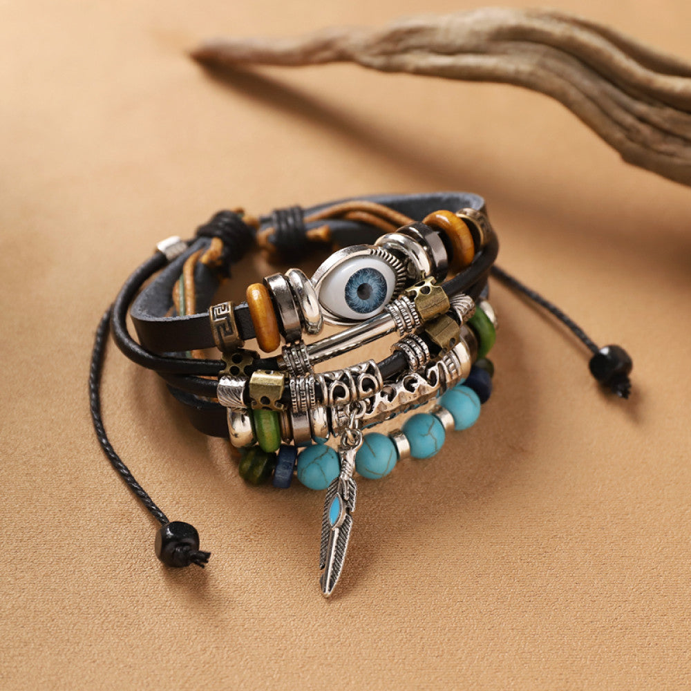 This bohemian stackable bracelet set features multiple layered strands in earthy tones, including turquoise, dark brown, green, and light brown beads, accented with decorative silver elements. The mix of natural materials and ethnic-inspired details creates a rich, textured look, perfect for layering to elevate casual outfits 000