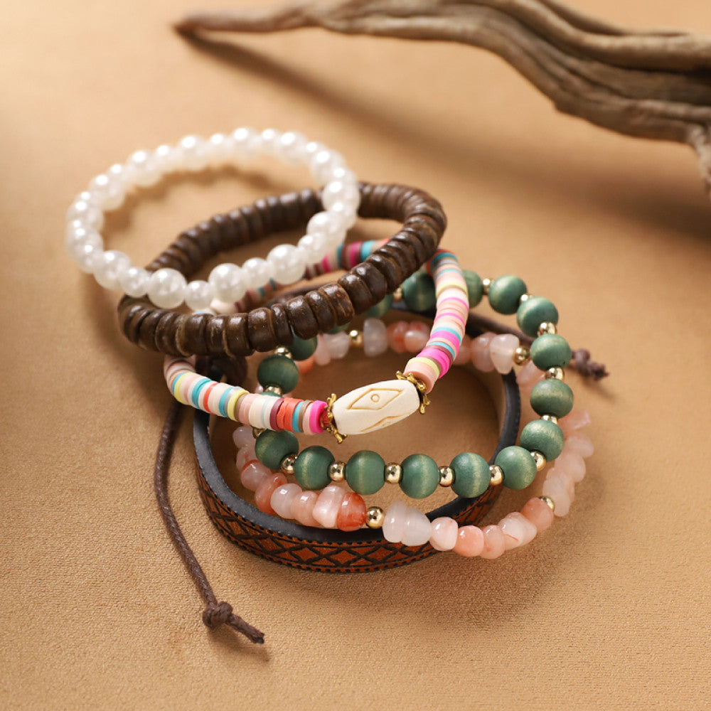 This bohemian stackable bracelet set features multiple layered strands in earthy tones, including turquoise, dark brown, green, and light brown beads, accented with decorative silver elements. The mix of natural materials and ethnic-inspired details creates a rich, textured look, perfect for layering to elevate casual outfits 03