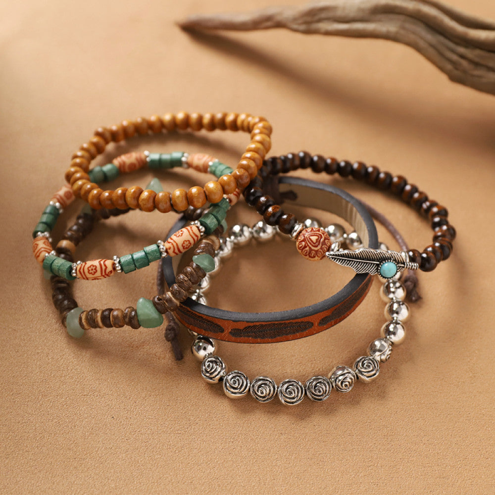 This bohemian stackable bracelet set features multiple layered strands in earthy tones, including turquoise, dark brown, green, and light brown beads, accented with decorative silver elements. The mix of natural materials and ethnic-inspired details creates a rich, textured look, perfect for layering to elevate casual outfits 04