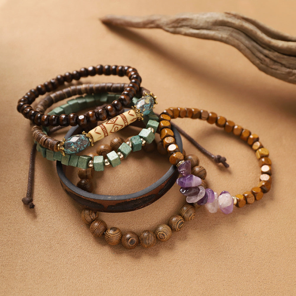This bohemian stackable bracelet set features multiple layered strands in earthy tones, including turquoise, dark brown, green, and light brown beads, accented with decorative silver elements. The mix of natural materials and ethnic-inspired details creates a rich, textured look, perfect for layering to elevate casual outfits 08