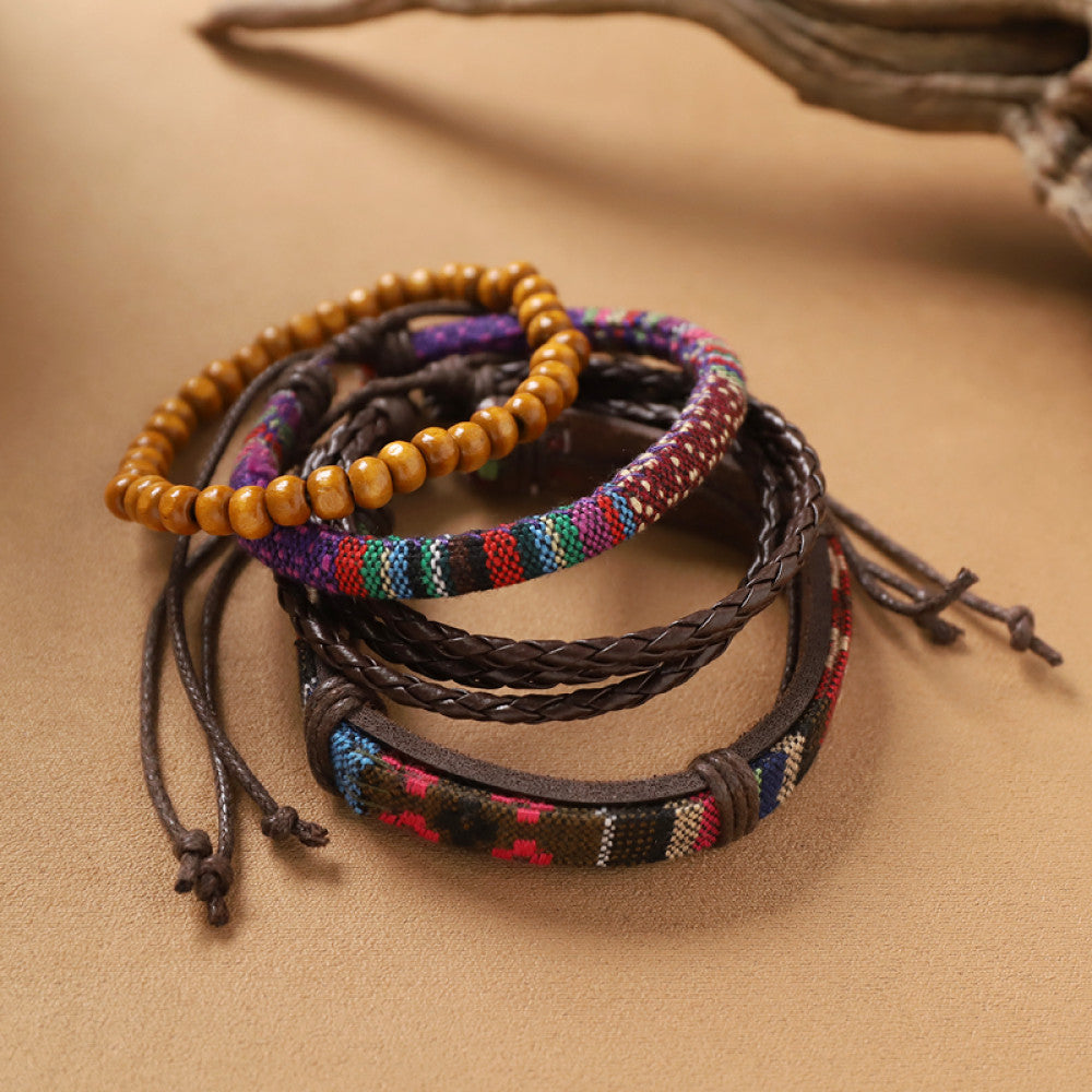 This bohemian stackable bracelet set features multiple layered strands in earthy tones, including turquoise, dark brown, green, and light brown beads, accented with decorative silver elements. The mix of natural materials and ethnic-inspired details creates a rich, textured look, perfect for layering to elevate casual outfits 1