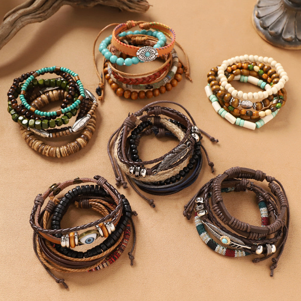 This bohemian stackable bracelet set features multiple layered strands in earthy tones, including turquoise, dark brown, green, and light brown beads, accented with decorative silver elements. The mix of natural materials and ethnic-inspired details creates a rich, textured look, perfect for layering to elevate casual outfits 123