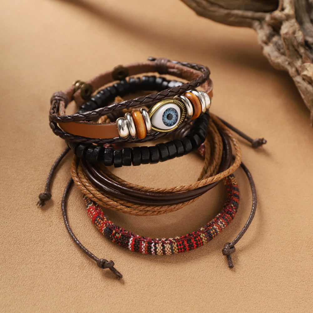 This bohemian stackable bracelet set features multiple layered strands in earthy tones, including turquoise, dark brown, green, and light brown beads, accented with decorative silver elements. The mix of natural materials and ethnic-inspired details creates a rich, textured look, perfect for layering to elevate casual outfits 4