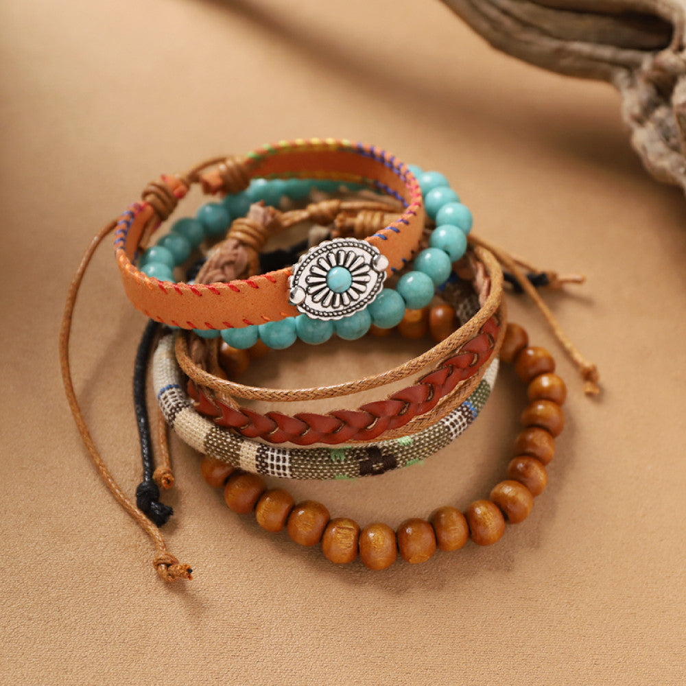 This bohemian stackable bracelet set features multiple layered strands in earthy tones, including turquoise, dark brown, green, and light brown beads, accented with decorative silver elements. The mix of natural materials and ethnic-inspired details creates a rich, textured look, perfect for layering to elevate casual outfits 5