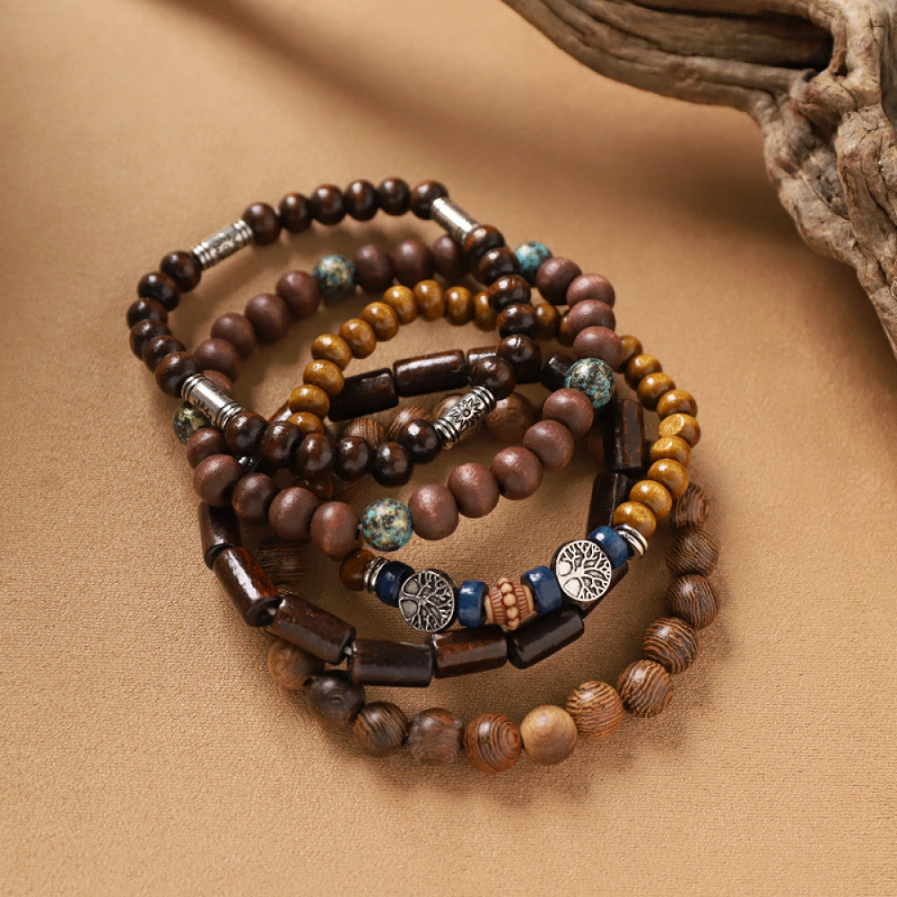 This bohemian stackable bracelet set features multiple layered strands in earthy tones, including turquoise, dark brown, green, and light brown beads, accented with decorative silver elements. The mix of natural materials and ethnic-inspired details creates a rich, textured look, perfect for layering to elevate casual outfits 7