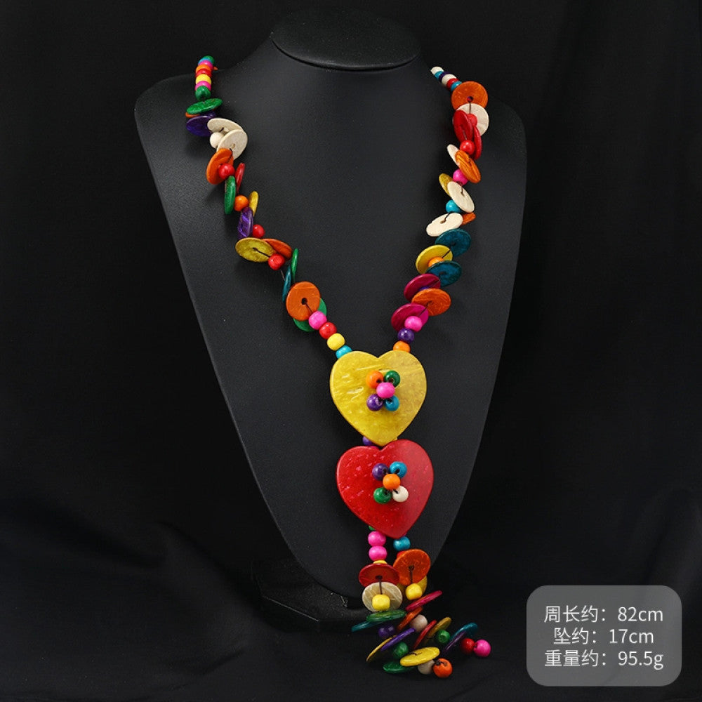 Vintage bohemian colorful shell and beaded necklace with tropical floral pendant, featuring multi-color beads and shell accents, ideal for boho beach and ethnic fashion, displayed on a black mannequin against a dark background 03