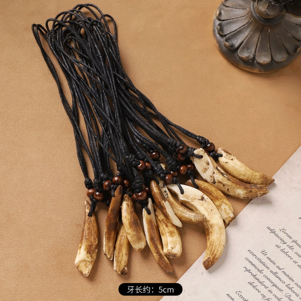 Vintage bohemian ethnic necklace set with animal tooth pendants, black leather cords, and bead accents, displayed against a neutral background with decorative elements, ideal for tribal and boho fashion enthusiasts 01