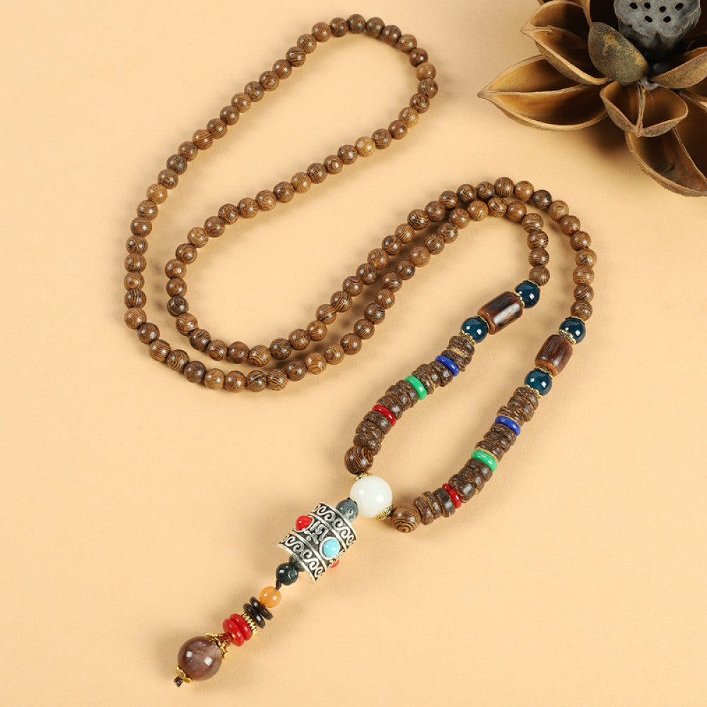 Vintage bohemian ethnic beaded necklace with jade pendant and multi-color beads, ideal for spiritual boho fashion, displayed with a decorative flower against a neutral background 05