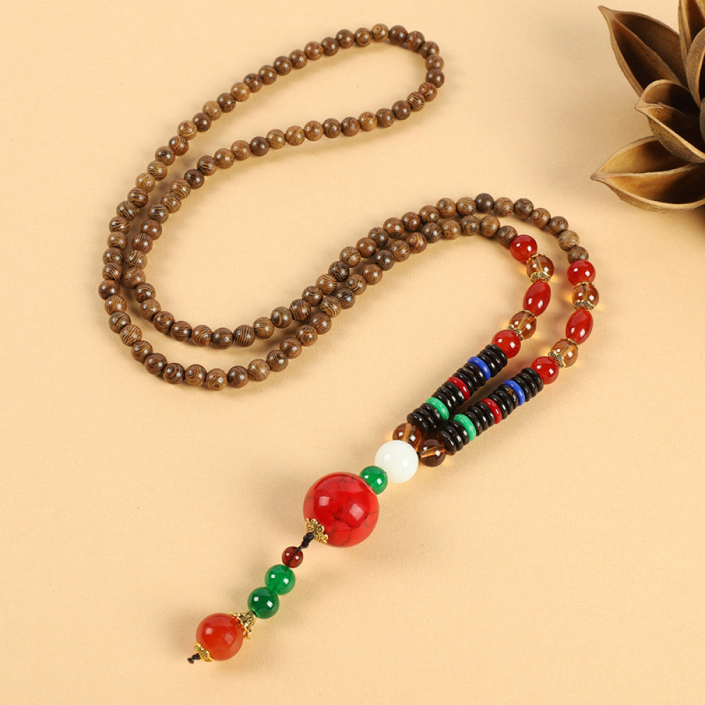 Vintage bohemian ethnic beaded necklace with jade pendant and multi-color beads, ideal for spiritual boho fashion, displayed with a decorative flower against a neutral background 06