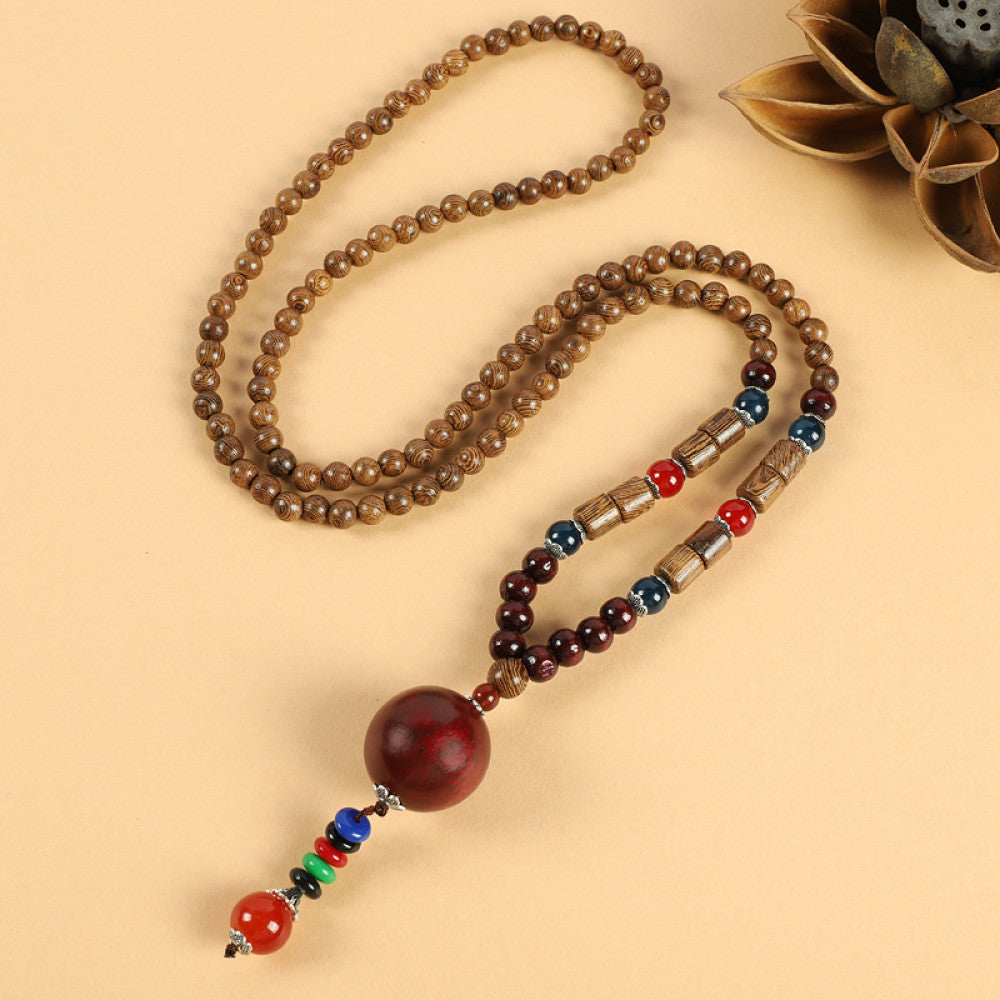 Vintage bohemian ethnic beaded necklace with jade pendant and multi-color beads, ideal for spiritual boho fashion, displayed with a decorative flower against a neutral background 09