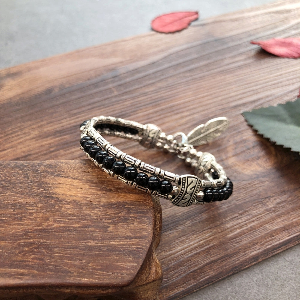 Vintage bohemian ethnic black beaded bracelet with silver engraved accents, displayed on a wooden surface, ideal for boho fashion enthusiasts 04