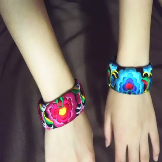 Vintage bohemian ethnic embroidered cuff bracelet with colorful floral design and black bead chain, displayed on wooden surface, ideal for boho and ethnic fashion enthusiasts 01