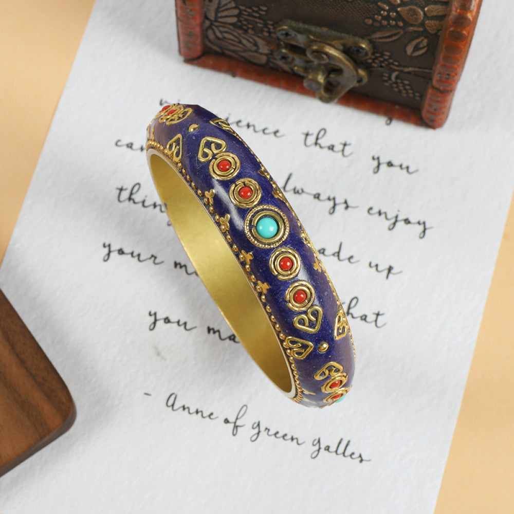 Vintage bohemian ethnic enamel bangle with colorful stone inlays and gold-tone accents, displayed on paper with decorative text and a vintage box, ideal for boho fashion enthusiasts