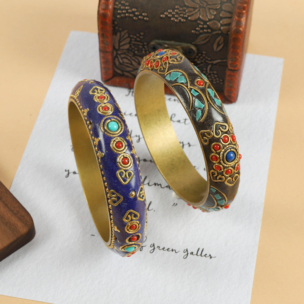 Vintage bohemian ethnic enamel bangle set with colorful stone inlays, featuring blue and brown designs, displayed on paper with a vintage box, ideal for boho fashion enthusiasts
