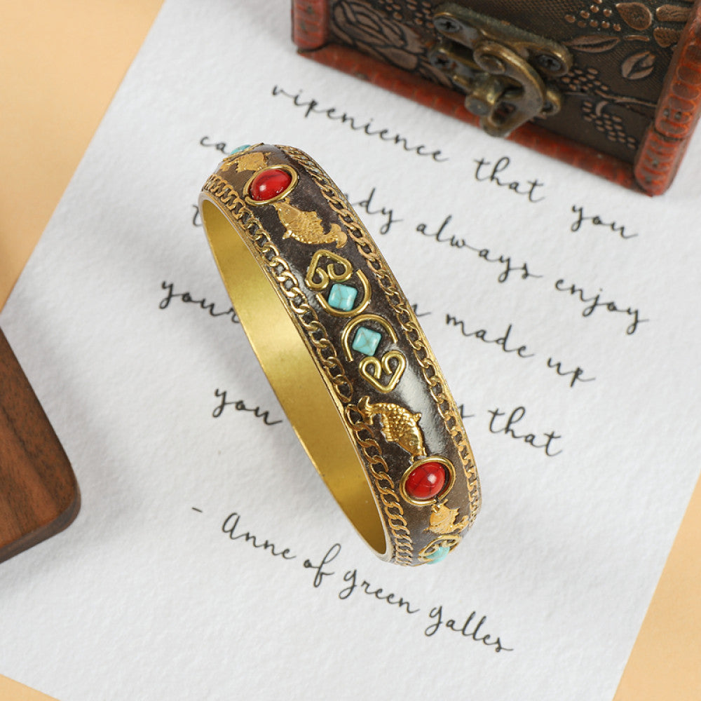 Vintage bohemian ethnic enamel bangle with turquoise and red stone inlays, gold-tone textured design, displayed on paper with decorative text and a vintage box, ideal for boho fashion enthusiasts 01