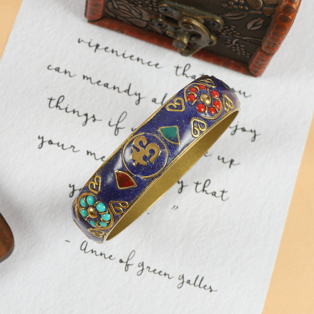 Vintage bohemian ethnic enamel bangle with turquoise and red stone inlays, gold-tone textured design, displayed on paper with decorative text and a vintage box, ideal for boho fashion enthusiasts 02