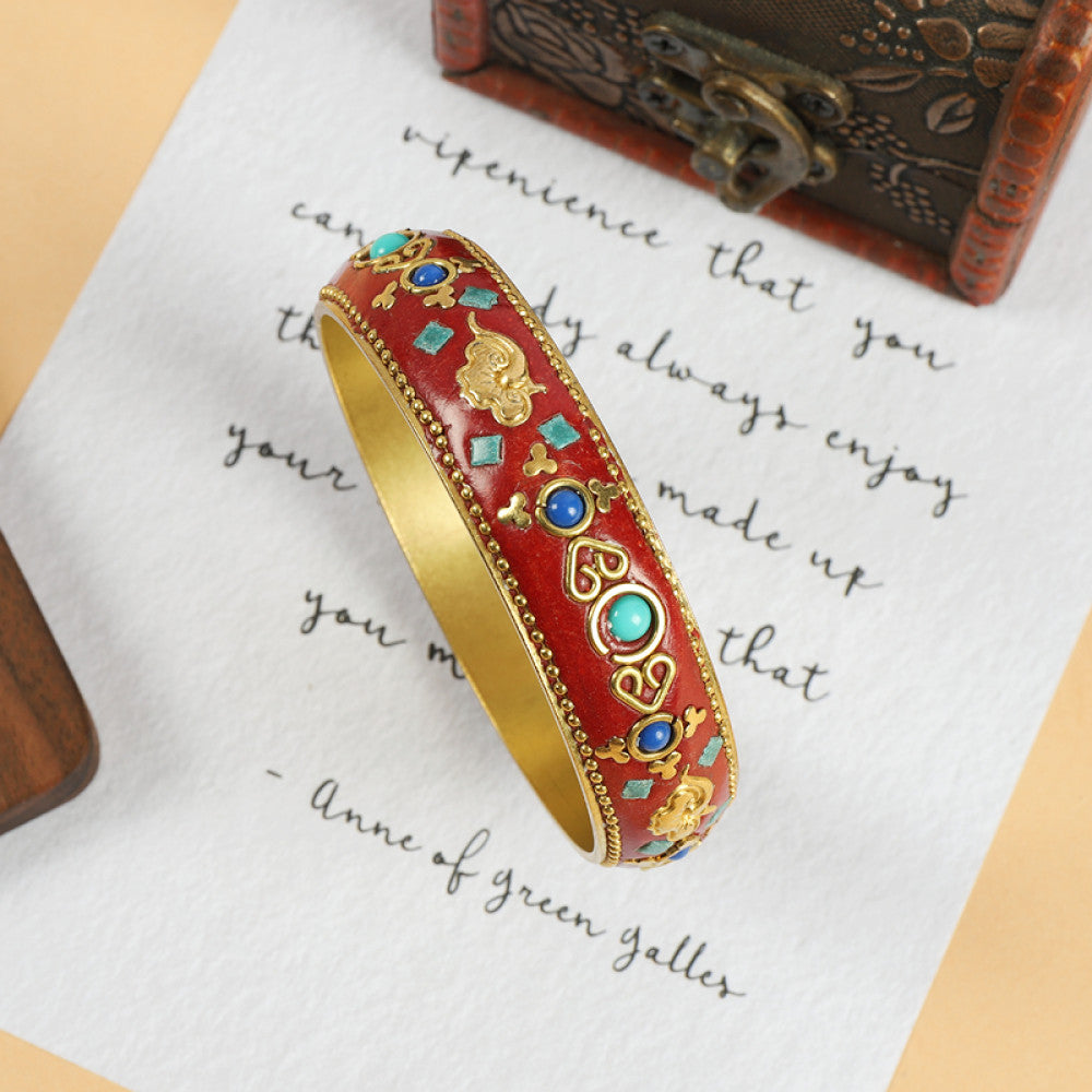 Vintage bohemian ethnic enamel bangle with turquoise and red stone inlays, gold-tone textured design, displayed on paper with decorative text and a vintage box, ideal for boho fashion enthusiasts 05