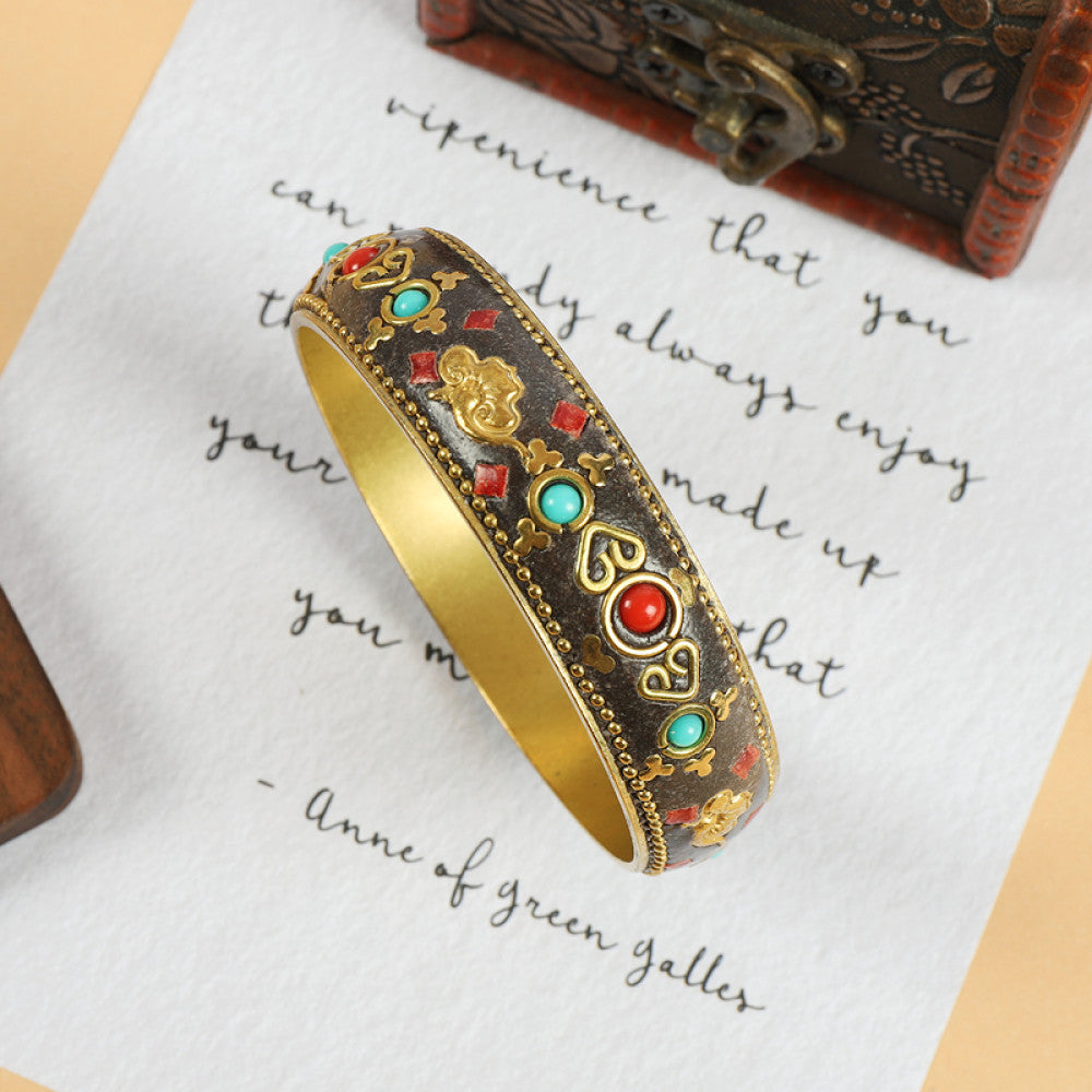 Vintage bohemian ethnic enamel bangle with turquoise and red stone inlays, gold-tone textured design, displayed on paper with decorative text and a vintage box, ideal for boho fashion enthusiasts 06