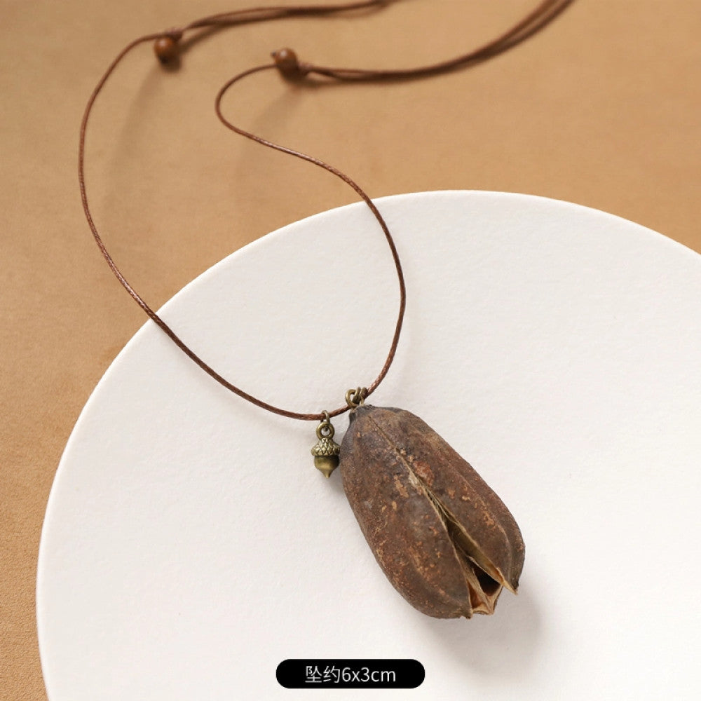 Vintage bohemian ethnic necklace with round natural stone pendant, featuring earthy brown tones and cord design, displayed on a neutral background with linen accent, ideal for boho fashion enthusiasts 02