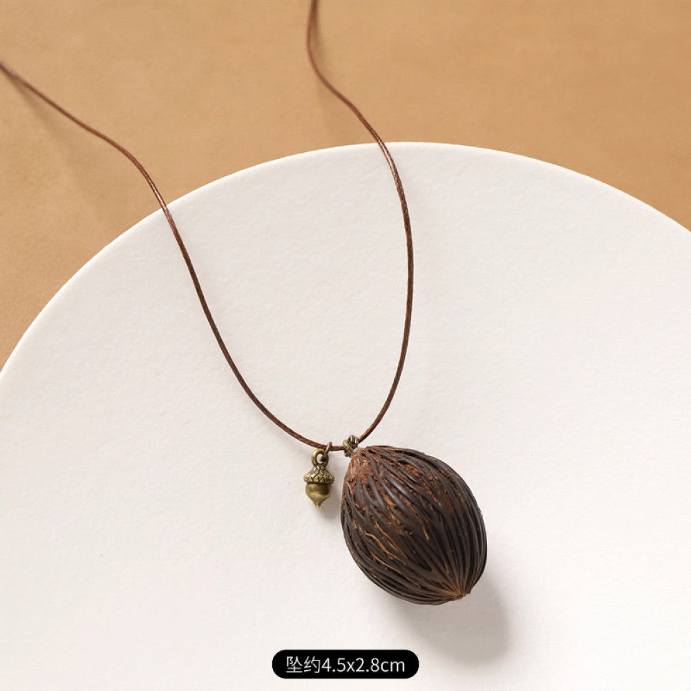 Vintage bohemian ethnic necklace with round natural stone pendant, featuring earthy brown tones and cord design, displayed on a neutral background with linen accent, ideal for boho fashion enthusiasts 09