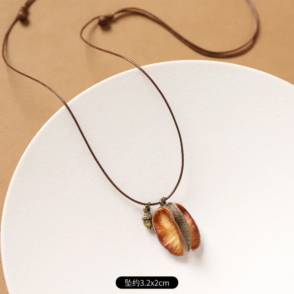 Vintage bohemian ethnic necklace with round natural stone pendant, featuring earthy brown tones and cord design, displayed on a neutral background with linen accent, ideal for boho fashion enthusiasts 14