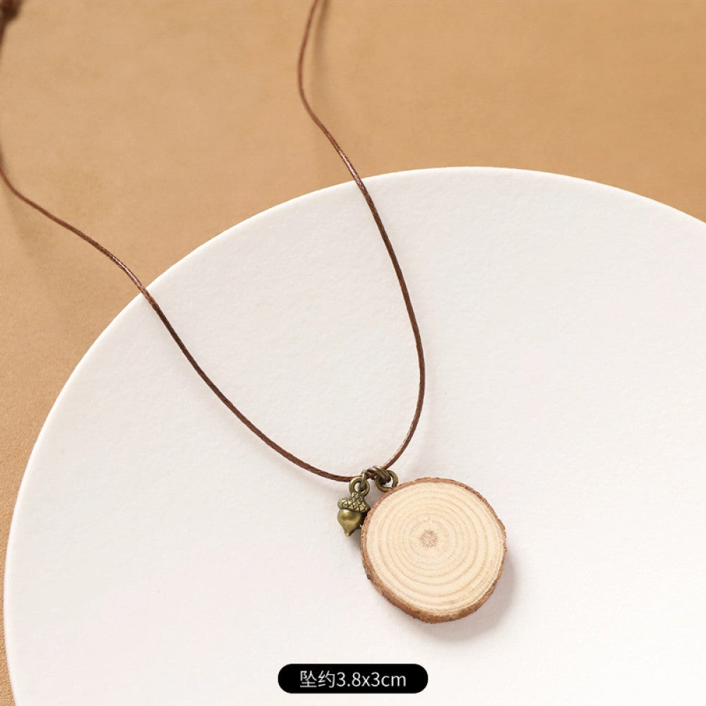 Vintage bohemian ethnic necklace with natural seed pendant, featuring earthy brown tones and cord design, displayed on a white plate against a neutral background, ideal for boho fashion enthusiasts 01