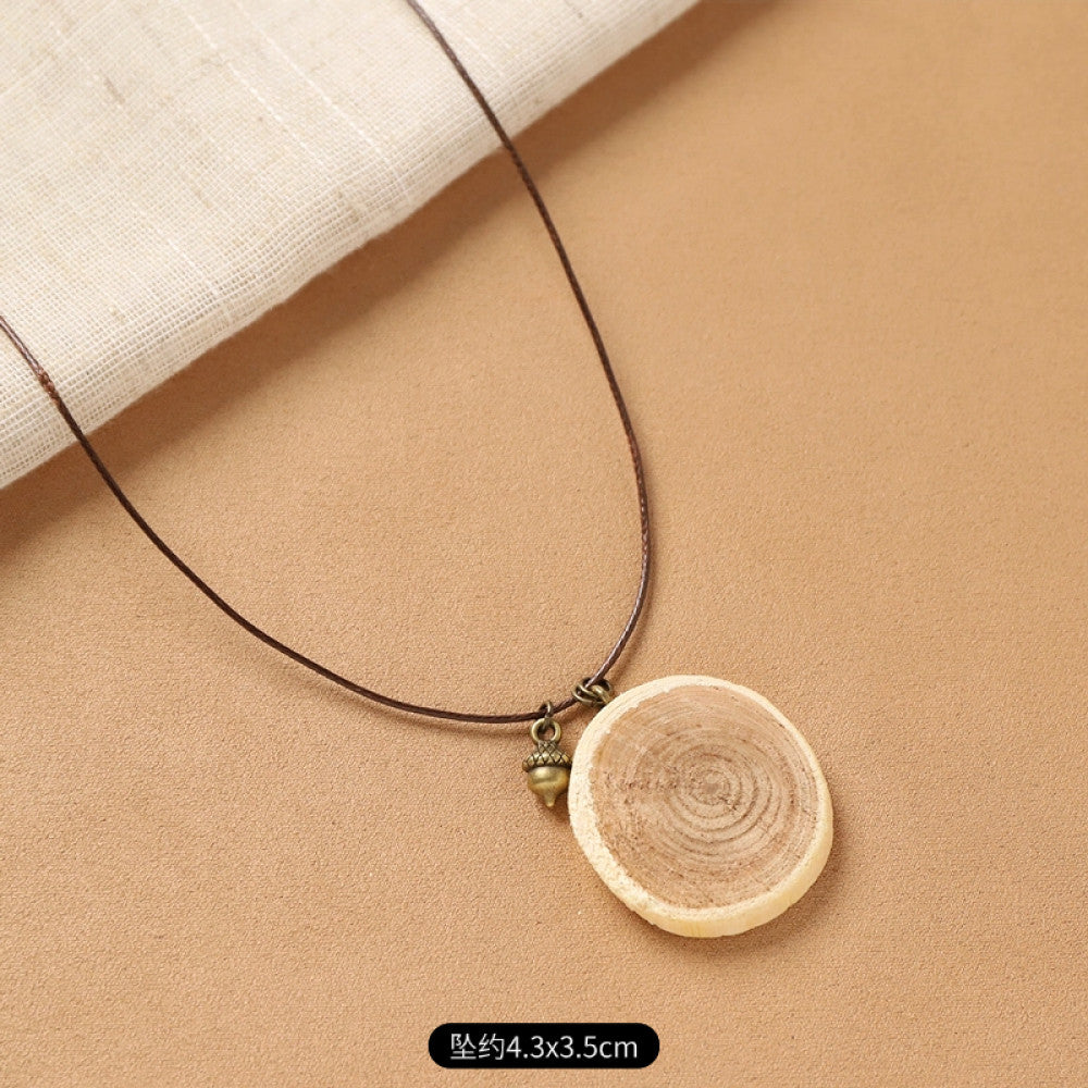 Vintage bohemian ethnic necklace with natural seed pendant, featuring earthy brown tones and cord design, displayed on a white plate against a neutral background, ideal for boho fashion enthusiasts 13