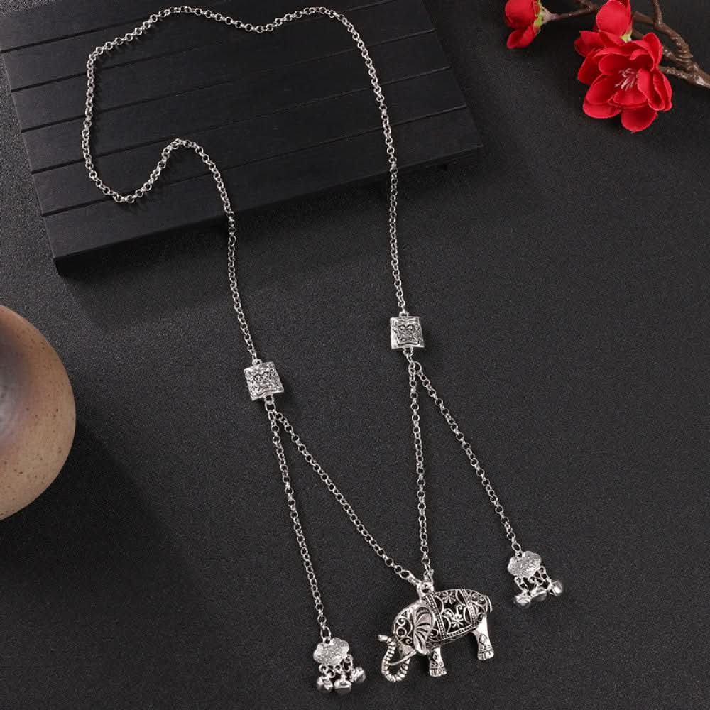 Vintage bohemian ethnic silver-tone necklace with Double Happiness pendant and filigree details, displayed on a dark background with red flowers, ideal for boho fashion and cultural-inspired styling 03