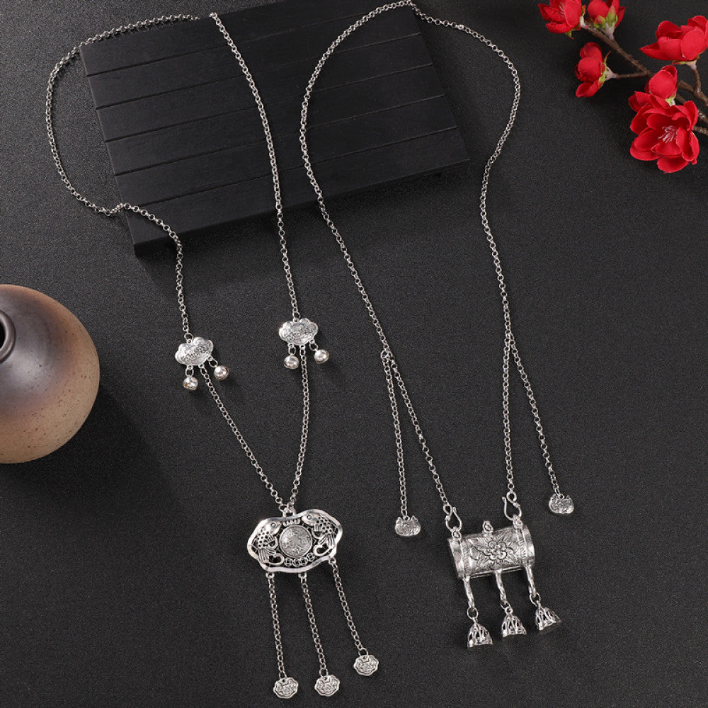 Vintage bohemian ethnic silver-tone necklace with Double Happiness pendant and filigree details, displayed on a dark background with red flowers, ideal for boho fashion and cultural-inspired styling 10