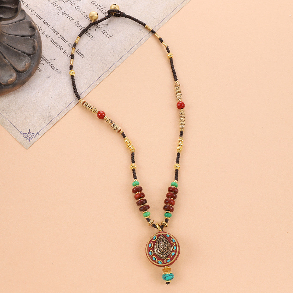 Vintage bohemian ethnic tribal beaded necklace with intricate colorful pendant and multi-color beads, ideal for boho fashion, displayed on a neutral background with vintage paper accent 04