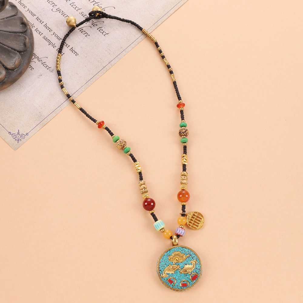 Vintage bohemian ethnic tribal beaded necklace with intricate colorful pendant and multi-color beads, ideal for boho fashion, displayed on a neutral background with vintage paper accent 06