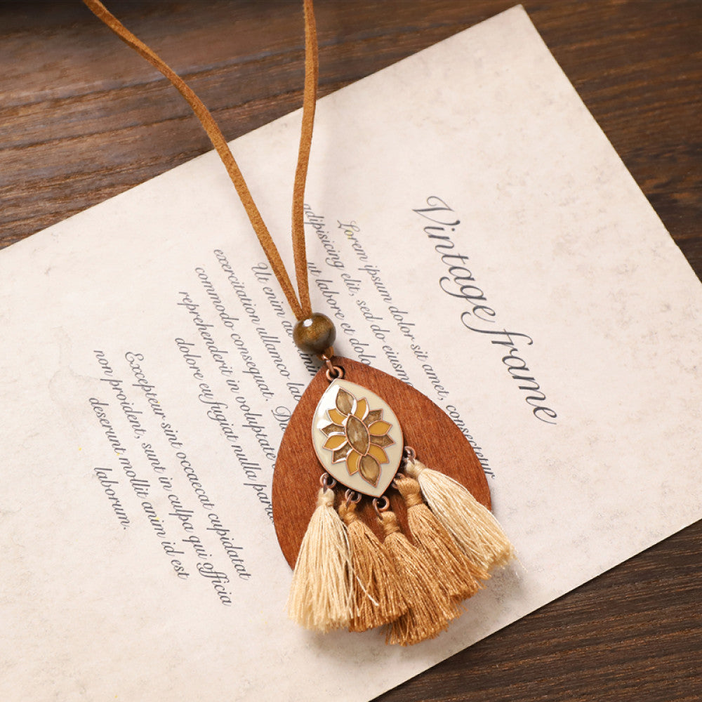 Vintage bohemian floral tassel necklace with beaded and fringe details, featuring earthy tones and intricate design, displayed on vintage paper, ideal for boho fashion enthusiasts 05