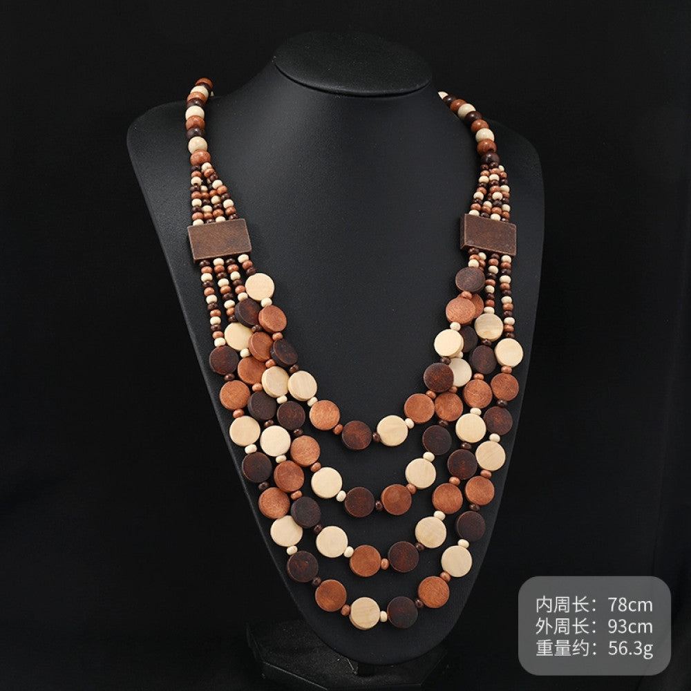 Vintage bohemian multi-layer wood beaded necklace with earthy tones, featuring intricate layered design, ideal for boho ethnic fashion, displayed on a black mannequin against a dark background