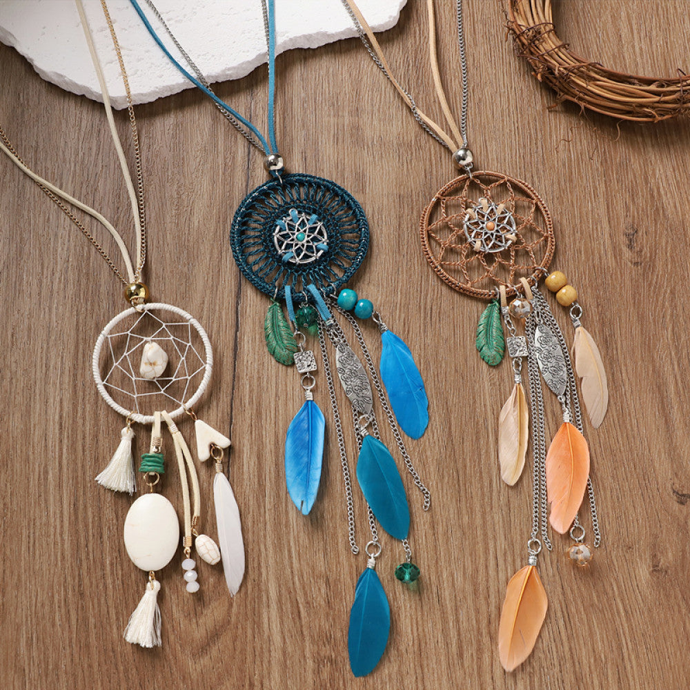 Assorted bohemian vintage dreamcatcher necklace set with multi-color designs, feather, shell, and bead accents, displayed on a wooden surface, ideal for boho fashion enthusiasts