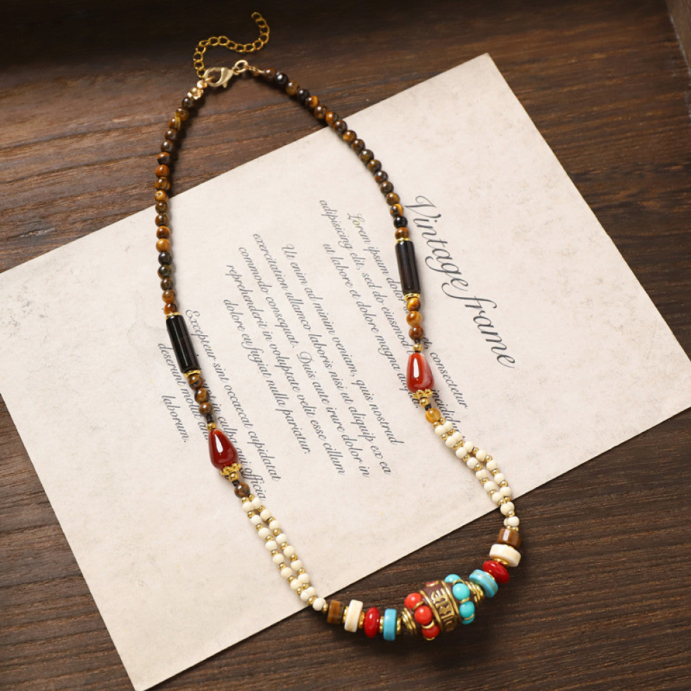 Vintage tribal-style necklace with turquoise and red beads, featuring a mix of geometric and round bead designs, ideal for bohemian fashion, showcased on vintage paper with elegant typography 03